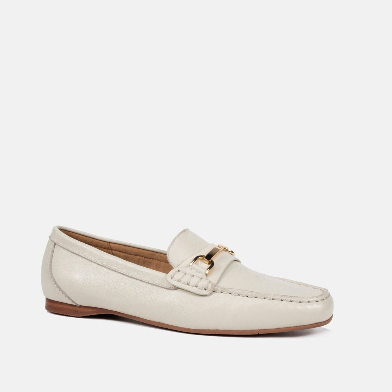 White loafer shoe on a light beige background